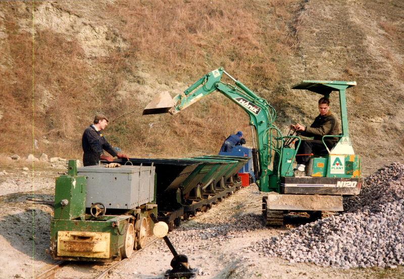 ballast-loading-1.jpg - The use of any mechanical aid is always welcome. This small digger proved invaluable in loading skip wagons with ballast for winter track repair work.